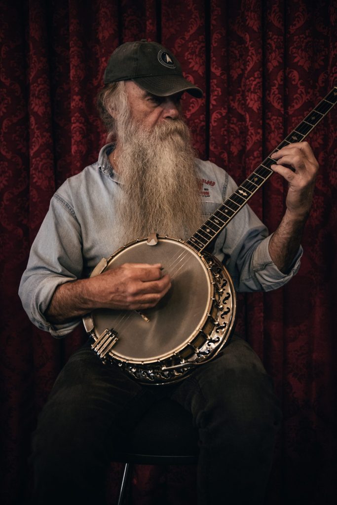 Banjo Player Focusing on Instrument